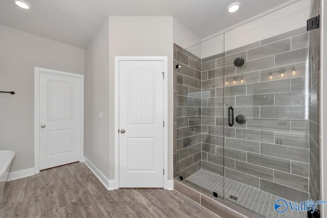 bathroom with wood-type flooring and walk in shower