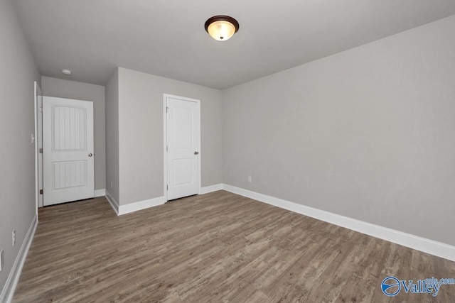 unfurnished bedroom with wood-type flooring