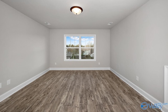 unfurnished room featuring dark hardwood / wood-style floors