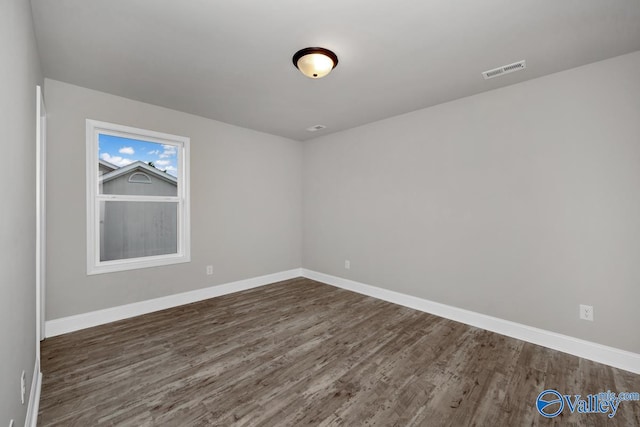 spare room featuring dark hardwood / wood-style floors