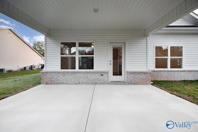 exterior space with central AC unit and a patio