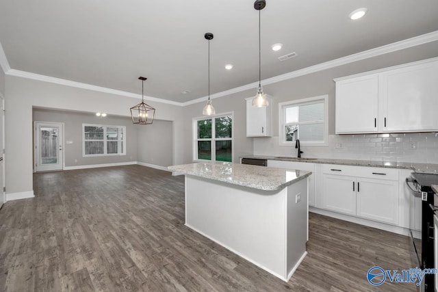 kitchen featuring dark hardwood / wood-style flooring, white cabinetry, sink, and a kitchen island