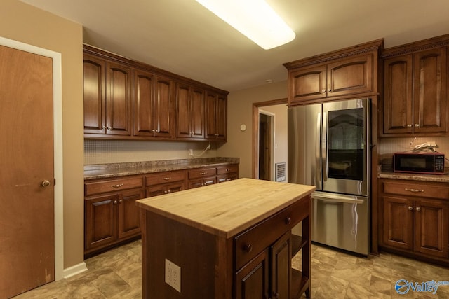 53 Price Mountain Dr, Decatur, AL 35603 - kitchen featuring smart refrigerator, black microwave, butcher block countertops, and a center island