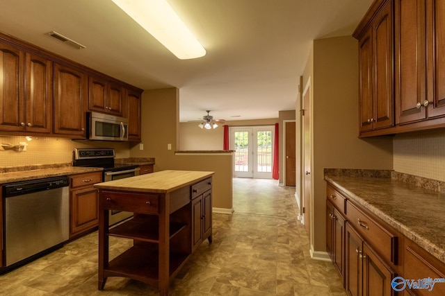 53 Price Mountain Dr, Decatur, AL 35603 - kitchen featuring stainless steel appliances, wood counters, backsplash, a ceiling fan, and open shelves