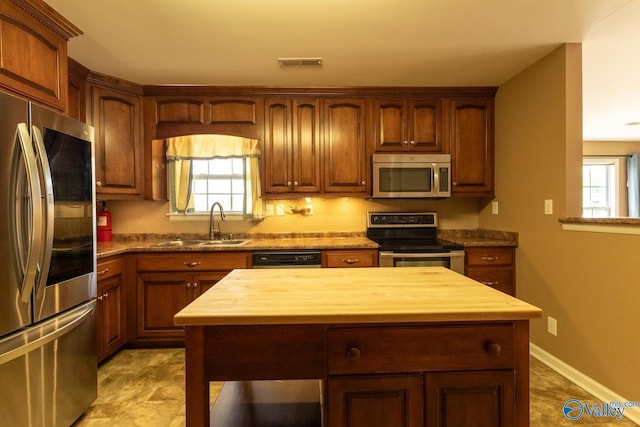 53 Price Mountain Dr, Decatur, AL 35603 - kitchen featuring appliances with stainless steel finishes, butcher block countertops, and healthy amount of natural light