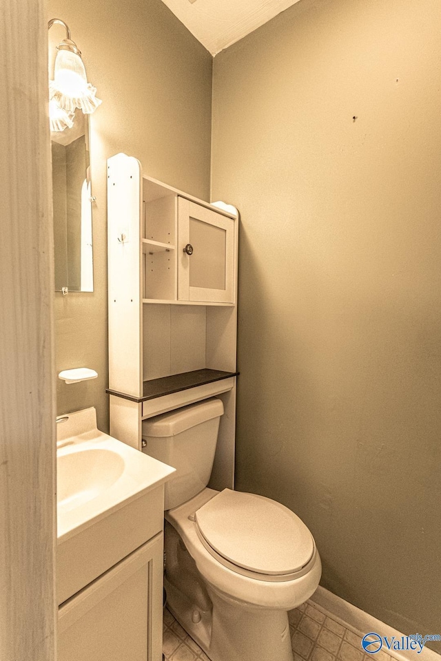 53 Price Mountain Dr, Decatur, AL 35603 - half bath with tile patterned flooring, toilet, vanity, and baseboards