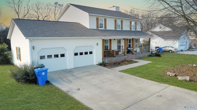 view of front facade with a porch, a lawn, and a garage