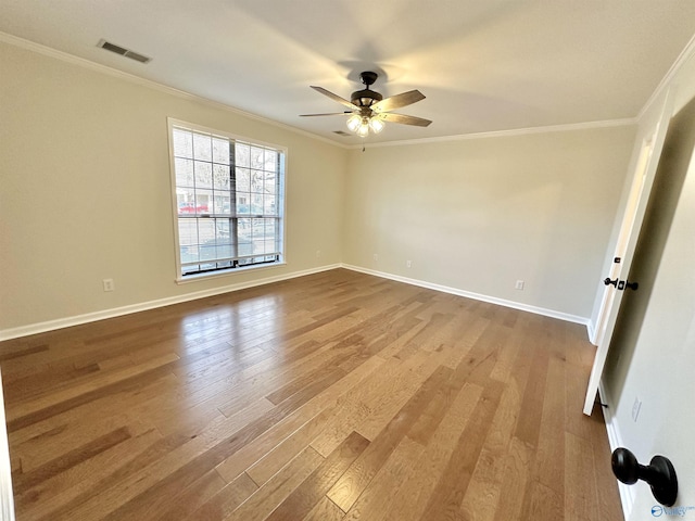 empty room featuring light hardwood / wood-style flooring, ornamental molding, and ceiling fan