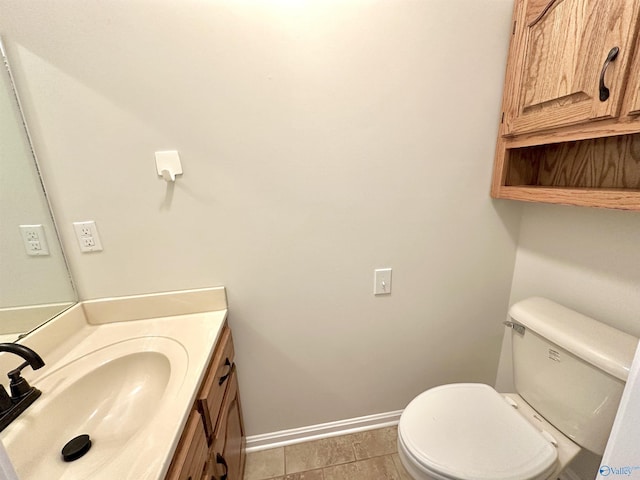 bathroom featuring vanity, tile patterned floors, and toilet