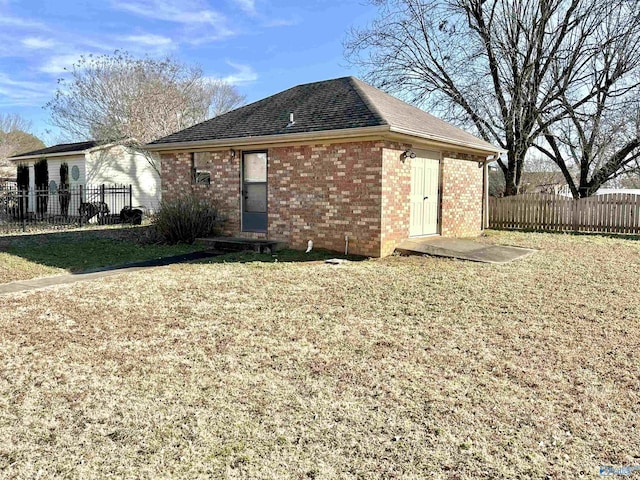 rear view of house featuring a yard