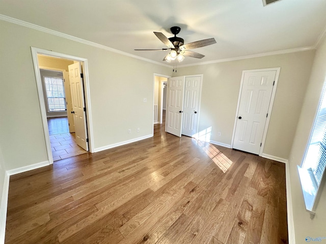 unfurnished bedroom featuring crown molding, ceiling fan, and light hardwood / wood-style floors