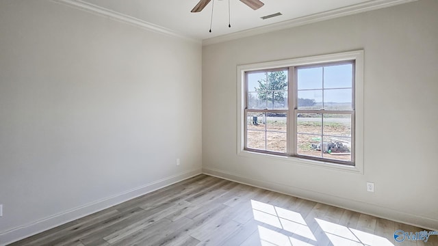 unfurnished room with ornamental molding, a healthy amount of sunlight, visible vents, and light wood finished floors