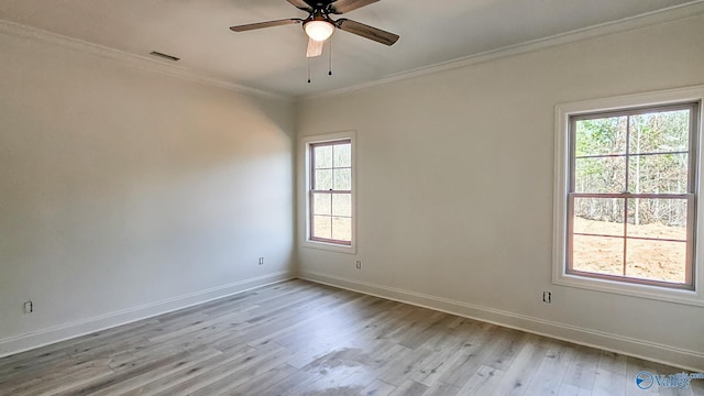 unfurnished room featuring baseboards, visible vents, a ceiling fan, wood finished floors, and crown molding