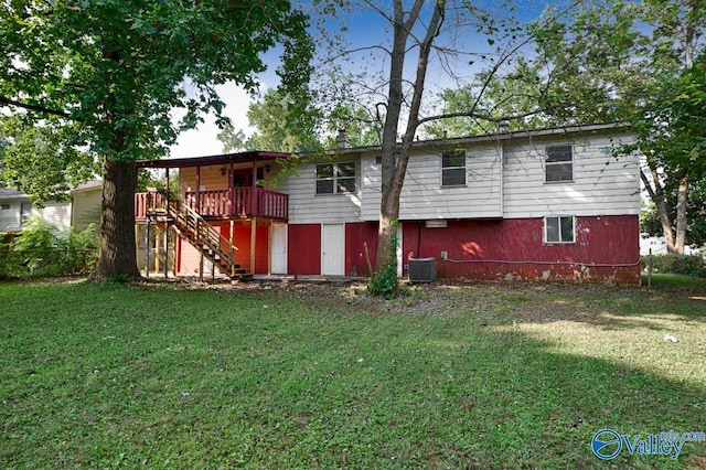 rear view of property featuring stairs, cooling unit, a deck, and a lawn