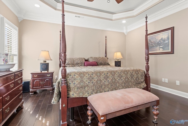 bedroom with a tray ceiling, ceiling fan, crown molding, and dark hardwood / wood-style floors