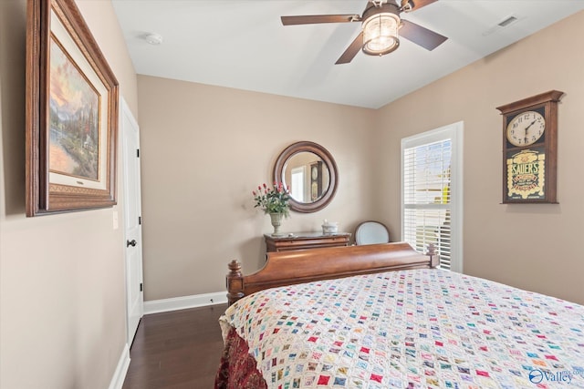 bedroom with dark hardwood / wood-style floors and ceiling fan