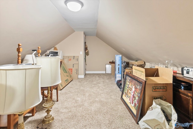 bonus room featuring light carpet and vaulted ceiling