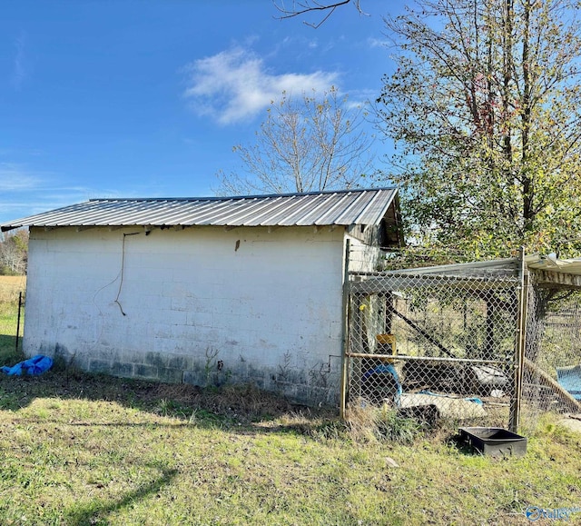 view of home's exterior with an outbuilding