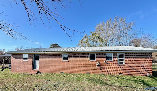 back of house with a lawn