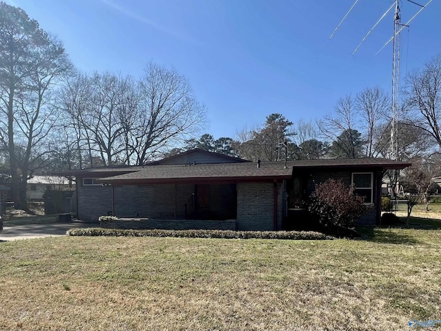 exterior space featuring a yard and brick siding