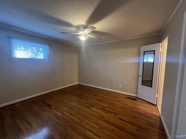 unfurnished room with a ceiling fan, wood finished floors, and crown molding