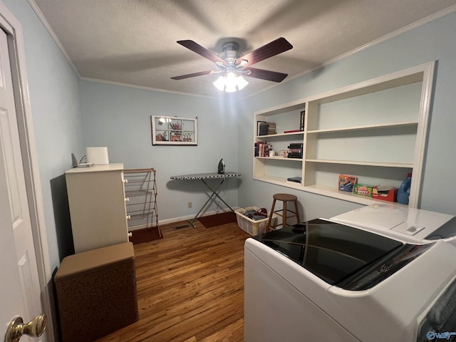 washroom featuring ceiling fan, wood finished floors, ornamental molding, and washer and clothes dryer