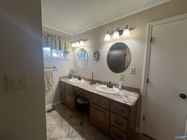 bathroom featuring a textured ceiling, double vanity, ornamental molding, and a sink