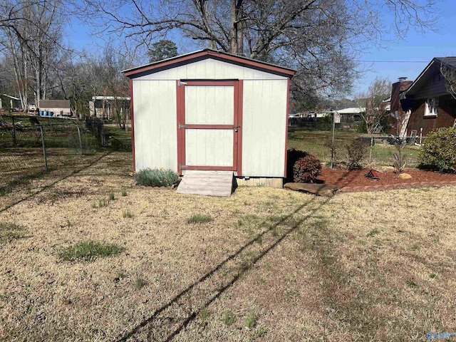 view of shed with fence