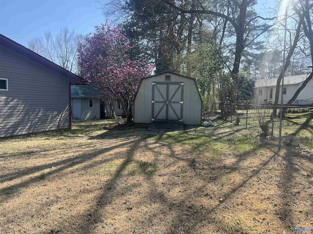 view of yard featuring a storage shed, an outdoor structure, and fence