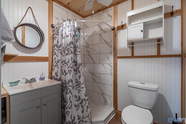 bathroom featuring vanity, ceiling fan, curtained shower, and toilet