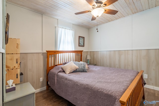 bedroom featuring dark wood-type flooring, ceiling fan, and wooden ceiling