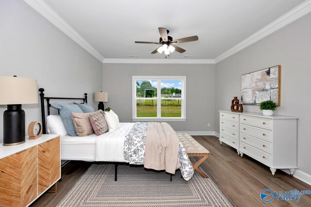 bedroom featuring dark wood-type flooring, ceiling fan, and crown molding