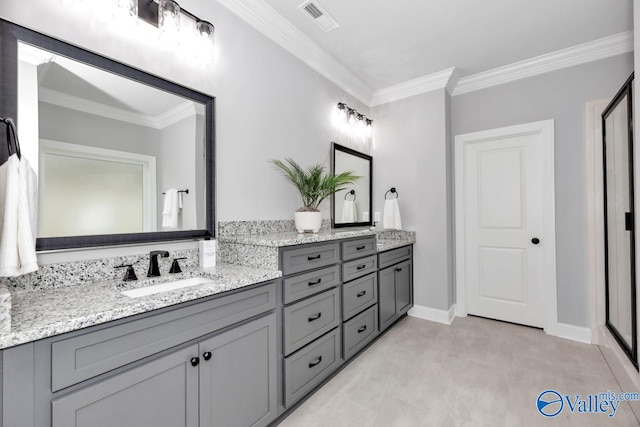 bathroom with ornamental molding and vanity