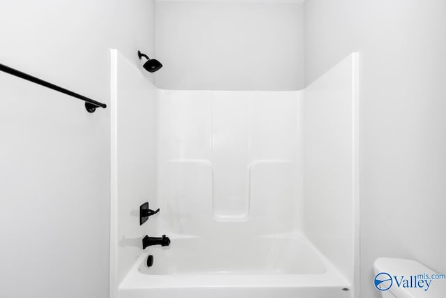 bathroom with shower / tub combination and toilet