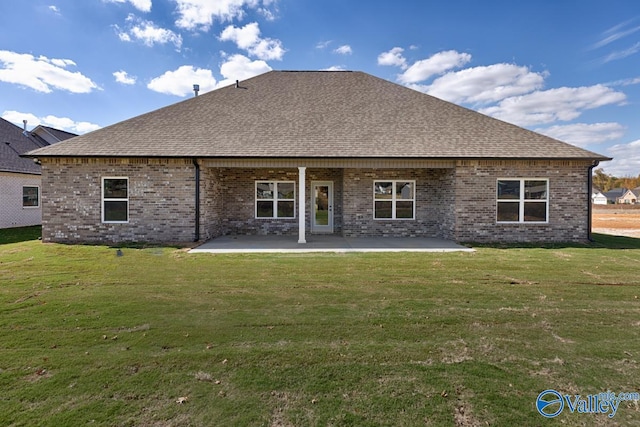 rear view of property featuring a yard and a patio area