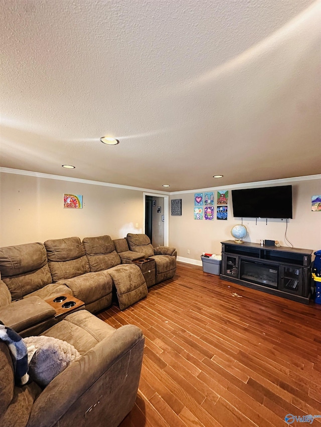 living room featuring ornamental molding, wood finished floors, baseboards, and a textured ceiling