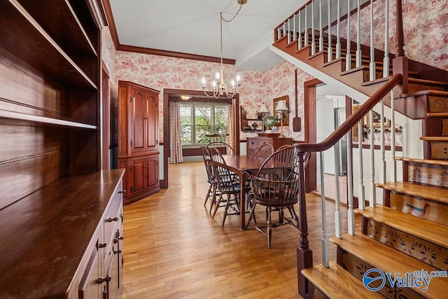 dining room with light wood-style flooring, ornamental molding, an inviting chandelier, wallpapered walls, and stairs