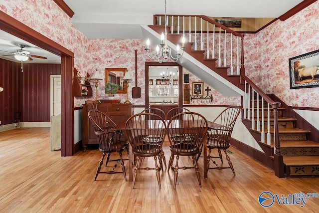 dining room with wallpapered walls, stairway, baseboards, and hardwood / wood-style floors