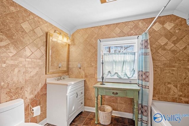 full bath featuring vanity, crown molding, toilet, tile walls, and tile patterned floors