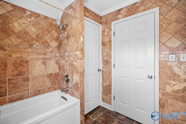 bathroom with tile walls, bathing tub / shower combination, and ornamental molding