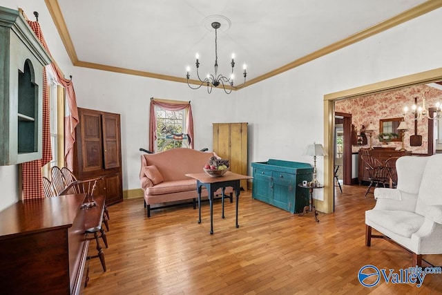 living area featuring light wood-style floors, baseboards, a notable chandelier, and crown molding