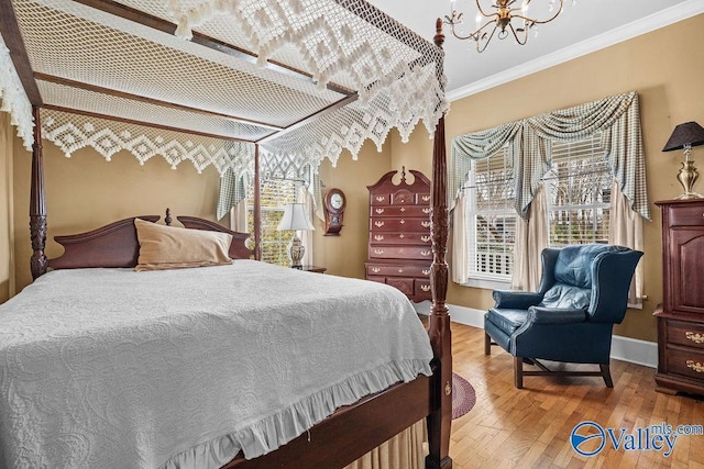 bedroom with multiple windows, a chandelier, crown molding, and hardwood / wood-style flooring