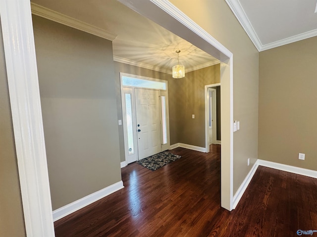 entrance foyer with ornamental molding, baseboards, dark wood-type flooring, and a notable chandelier