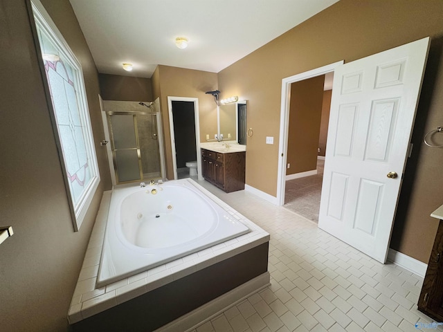 full bathroom with toilet, a tub with jets, vanity, a stall shower, and plenty of natural light