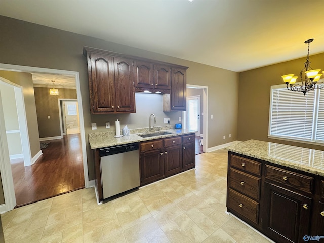 kitchen featuring a notable chandelier, light stone countertops, a sink, and stainless steel dishwasher