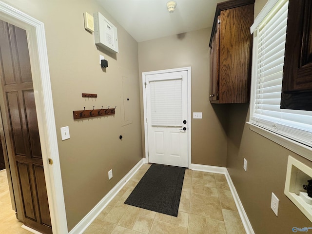 entryway with light tile patterned floors and baseboards