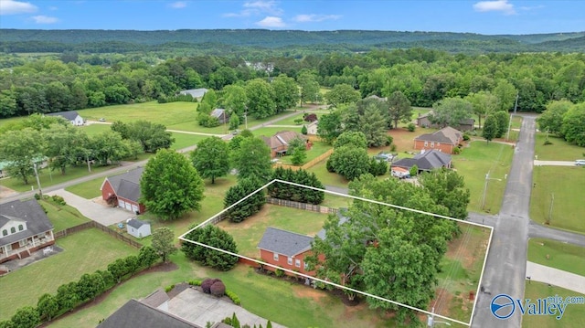 birds eye view of property with a view of trees