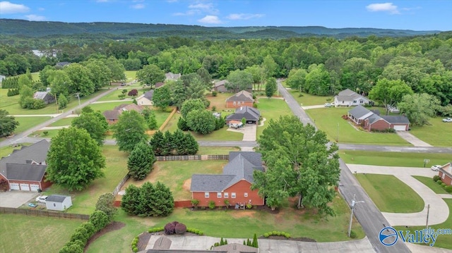 aerial view featuring a forest view and a residential view