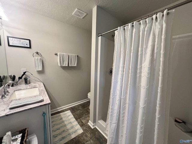 1006 SW 6th St, Attalla, AL 35954 - bathroom featuring vanity, toilet, a textured ceiling, a shower with curtain, and baseboards