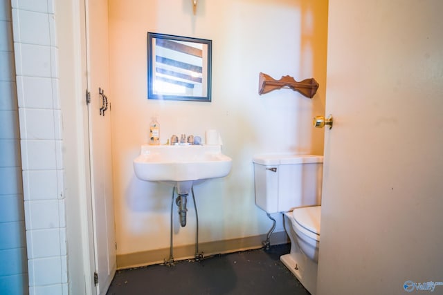 bathroom with toilet and concrete floors